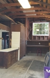 Interior of garage, with 15 ft ceilings, original buffet, storage cabinets, desk/workshop area