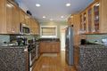 Remodeled kitchen with granite counters and stainless steel appliances