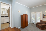 Primary suite, view of full bathroom and view of doors to backyard