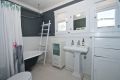 Bathroom with built-in cabinetry and clawfoot tub